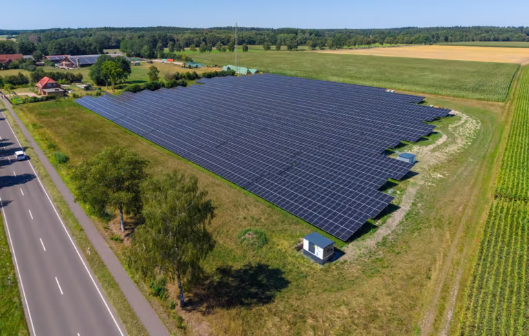 Munster-Alvern solar park in Lower Saxony Aerial view of the Munster-Alvern solar park in Lower Saxony with large-scale photovoltaic panels between fields and a country road